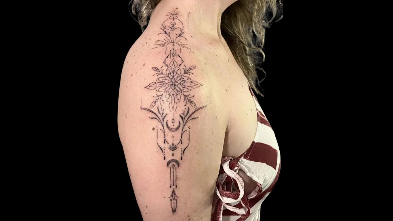 Fine-line ornamental tattoo with celestial motifs on a shoulder, from a single tattoo session
